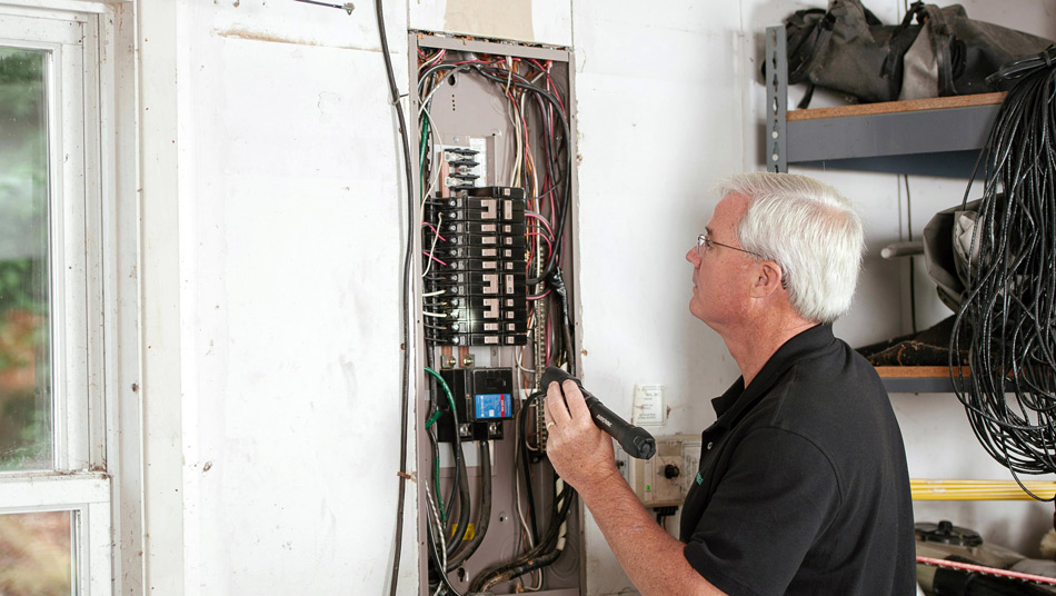 Man examining a home electrical panel